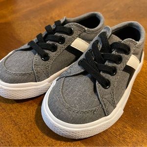 Black and white striped gray baby/toddler shoes.